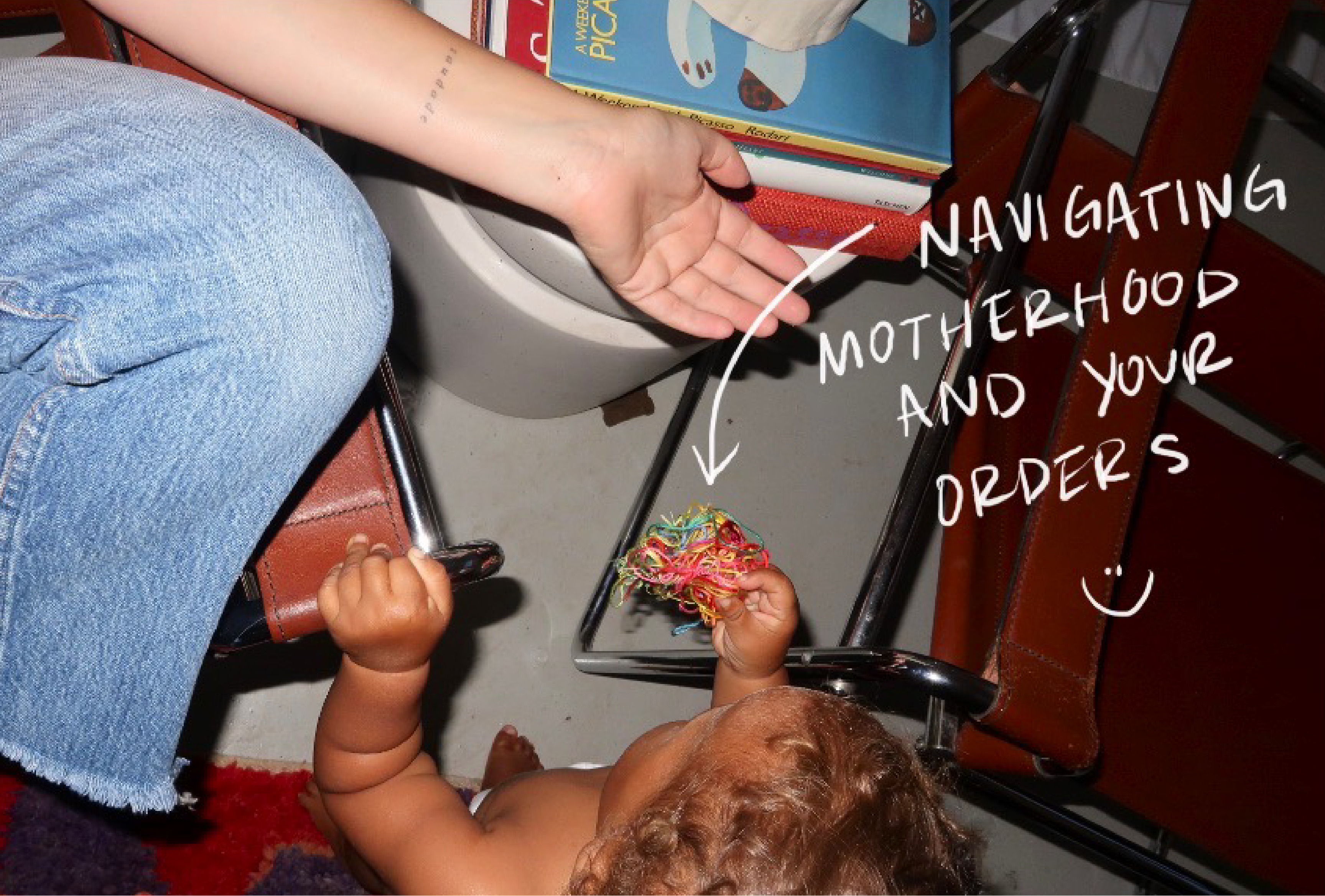 An aerial photo of Jenna's son handing her some balled up thread. The handwritten text on this image says "navigating motherhood and your orders".